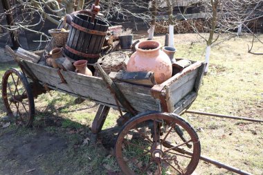 Seramik kaplar ve kırsal ahşap varillerle süslenmiş eski moda bir araba.