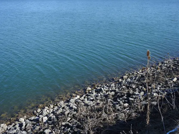 stock image rocks on the waters blue edge