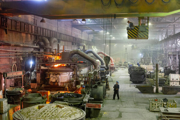 Metal manufacture factory line with a large steel smelting furnace inside