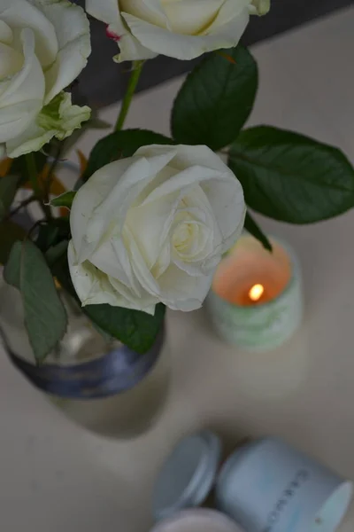 beautiful white roses and candles on a table