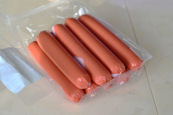 stock image Sausages lie on a light kitchen table