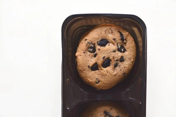 cookies with chocolate drops lie on the table in a box