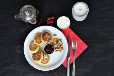 Peynirli krep tabağının yanında bir mum var.