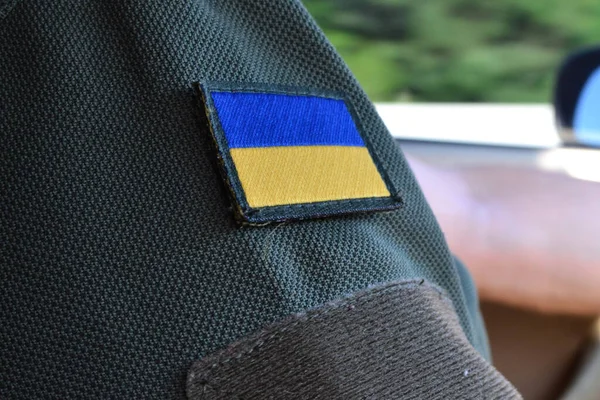 a Ukrainian military man is driving