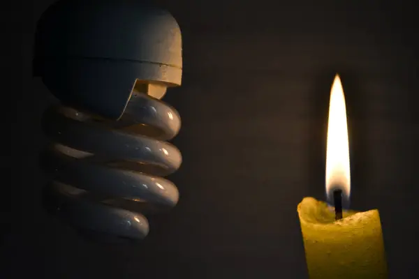lit candle near the light bulb