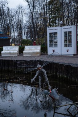 Kharkiv, Ukrayna - 12 Kasım 2023: Central Park 'ta bir dolap dolusu kitap ve bir peri masalı kahramanı heykeli duruyor.