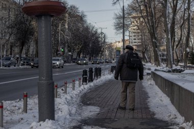 Kyiv, Ukrayna. 11 / 30 / 2023: bir vatandaş kış caddesi boyunca yürüyor