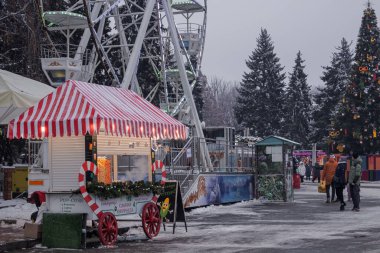 Kyiv, Ukrayna - 12 Aralık 2023: İnsanlar yeni yıl fuarına dinlenmek ve ızgarada taze yapılmış sokak yemekleri yemek için geldiler. Gerçek bir yiyecek ve içecek fuarı açıldı. İnsanlar sohbet eder ve dolaşır..
