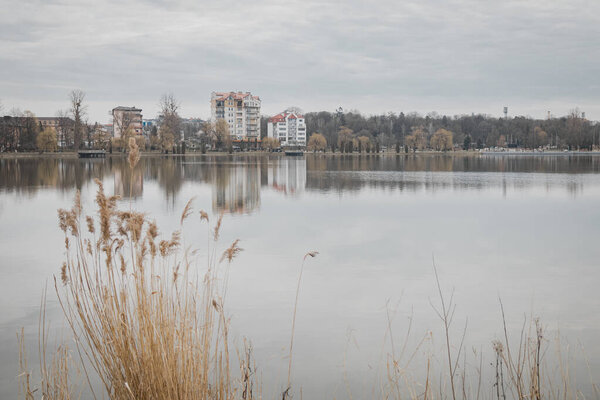 Ivano-Frankivsk, Ukraine. February 28, 2024, a small European city. At the end of February, the weather is very warm, people are walking by the lake. feed the birds and play sports