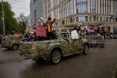 Kyiv, Ukrayna. 21 Nisan 2024 'te sağanak yağmur ve soğuk hava bile insanları durduramadı. Esir tutulan savaş esirlerine hatırlatmak ve desteklemek için bir kez daha şehrin merkezine gittiler..
