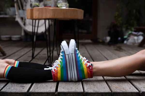 一对夫妇腿上穿着彩虹鞋的Lgbt符号 两个女同志穿着五颜六色的鞋子在外面 作为爱情 自由和多样性概念的两个性感女孩 — 图库照片