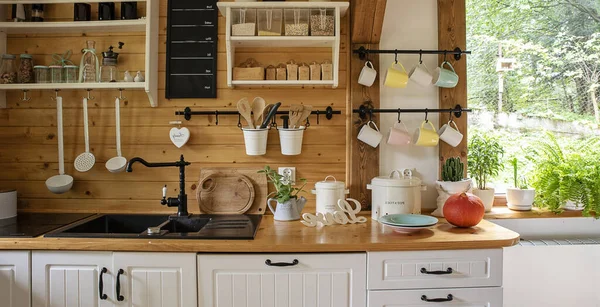 stock image Vintage rustic interior of kitchen with white furniture, wooden wall and rustical decor. Bright indoor.Banner.