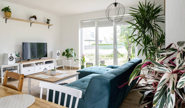 Modern living room with dining table in scandinavian interior. Comfortable sofa