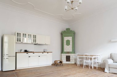 Kitchen interior in townhouse with space, white furniture, wooden floor and tiled stove, furnace. clipart