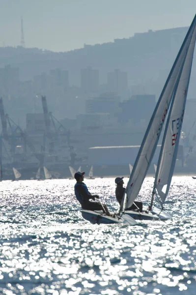 stock image Photo of two laser class sailboats silhuetted by the setting sun