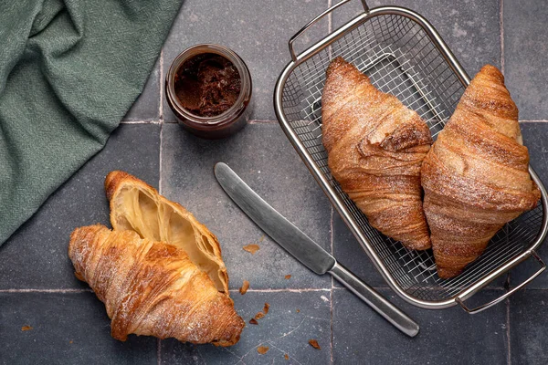 Food photography of croissant, breakfast, knife, chocolate cream