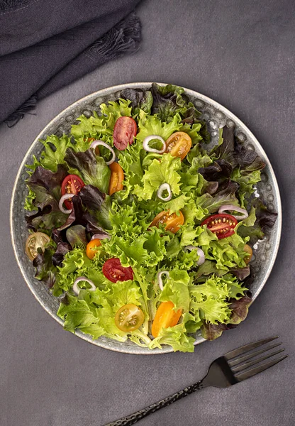 Food photography of salad; tomato; leaf; lettuce; onion, brunch; breakfast;  fork; background; raw, meal; food; cook; cuisine; nutrition