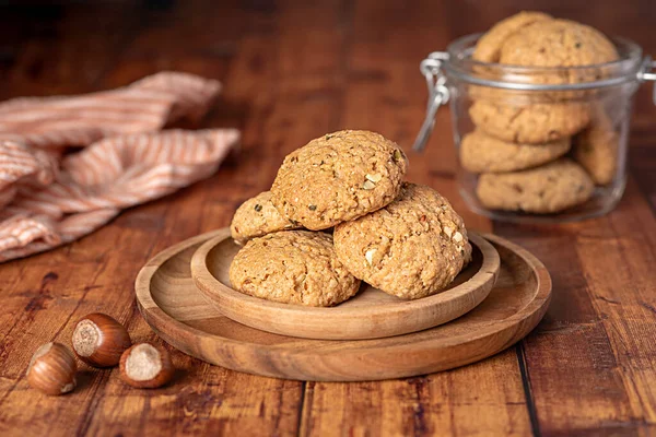 Food photography of oat biscuit; oatmeal; cookie;nut; hazelnut, pastry,  dessert, jar, glass, plate