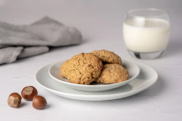 Food photography of oat biscuit; oatmeal; cookie;nut; hazelnut, pastry, milk, glass, plate