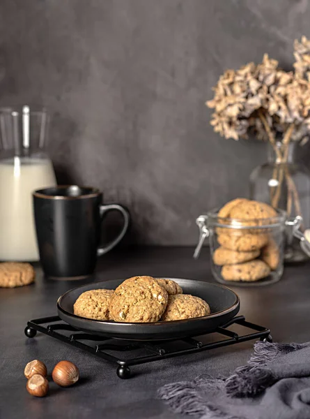 Food photography of oat biscuit; oatmeal; cookie;nut; hazelnut, pastry, milk, jar, glass, plate