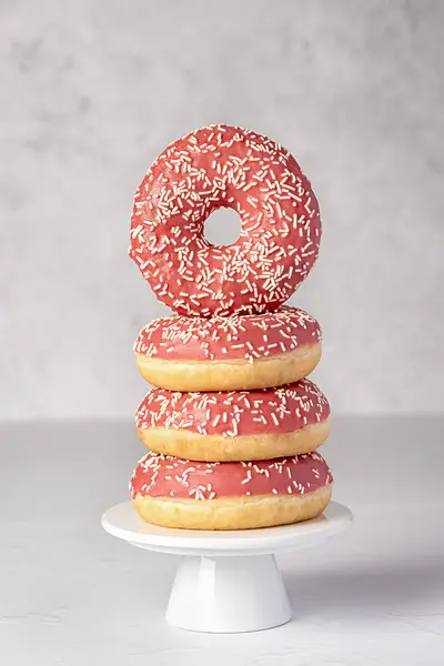 Food photography of donuts, glazed, bagel, bakery, baking, pastry, pink, treat, dessert, sprinkles, calories, icing, candy