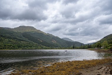 Landscape photography of lake Loch Long and mountains; moody sky with clouds; hill; viewpoint; scenic; rocky; destination; travel; hiking; hike; Scotland; UK; Arrochar clipart