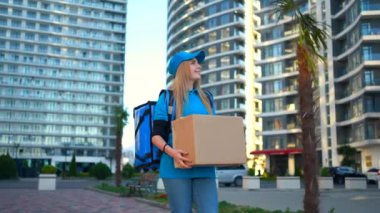 Genç bir kadın sırt çantası, kurye ya da mal ya da alımları müşteriye götüren bir teslimatçıdır.