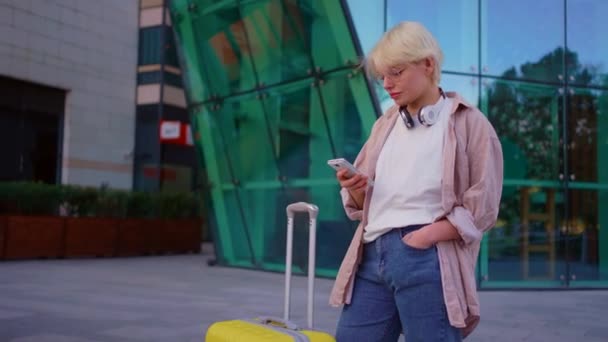 Young Attractive Female Traveler Headphones Smartphone Her Hands Looking Camera — Stock Video