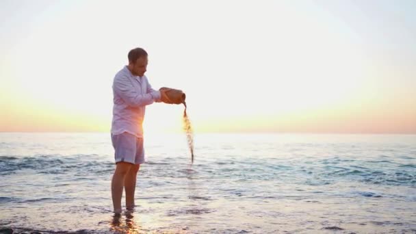 日没に水の上に灰を散らす美しい儀式 — ストック動画