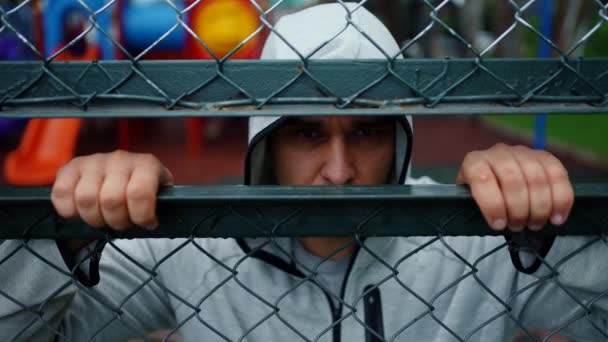 Portrait Criminal Man Bandit Hood Looking Fence Bars — Stock Video