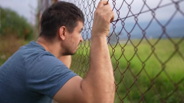 Man Looks Fence Bars Problem Illegal Immigration — Stock Video