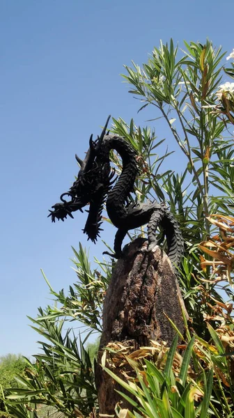 silhouette of black dragon against blue sky at taliesin west