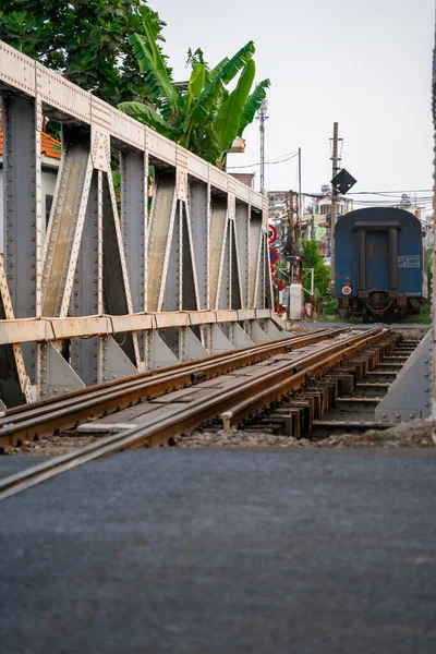 stock image Incredible view of train passing through a narrow street, the Hanoi Old Quarter. Tourists taking pictures of the train.