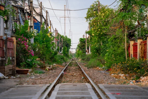 stock image Incredible view of train passing through a narrow street, the Hanoi Old Quarter. Tourists taking pictures of the train.