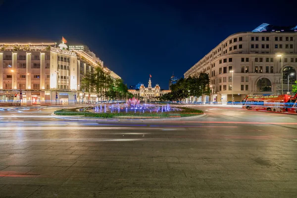 stock image Ho Chi Minh, Viet Nam - 10 April 2023: Saigon City Hall, Vincom Center towers, colorful street traffic & tropical plants against the amazing night. Saigon downtown with its famous landmarks.