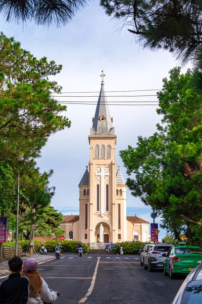 stock image Da Lat, Viet Nam - 3 June 2023: Looking towards Da Lat Cathedral, Chicken Church on a green road, located in Da Lat city, Lam Dong province. Tourism city in Vietnam developed.