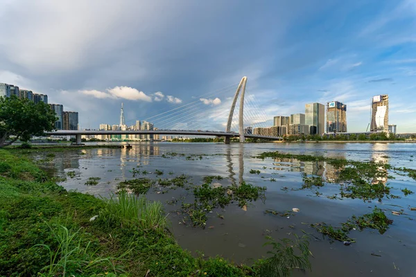 stock image Ho Chi Minh, Viet Nam - 8 July 2023: Skyline with Landmark 81 skyscraper, Thu Thiem 2 bridge, connecting Thu Thiem peninsula and District 1 across Saigon River at Bach Dang port