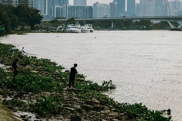 stock image Ho Chi Minh, Viet Nam - 12 July 2023: Ho Chi Minh City skyline and the Saigon River at sunset. Ho Chi Minh City is a popular tourist destination of Vietnam.