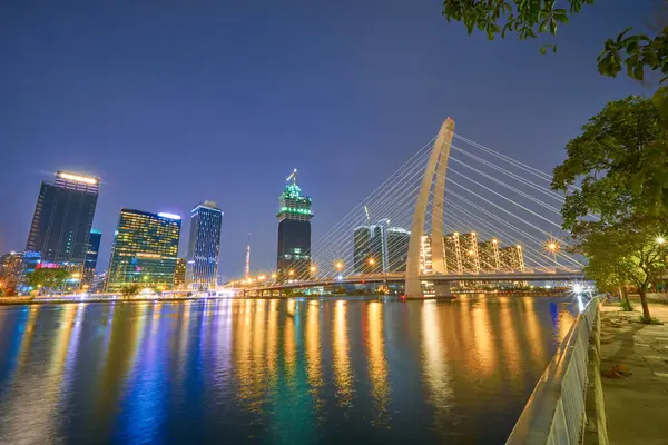 Stock image Ho Chi Minh, Viet Nam - 20 Jan 2024: Ho Chi Minh City skyline and the Saigon River. Amazing colorful night view of skyscraper and other modern buildings at downtown. Travel concept