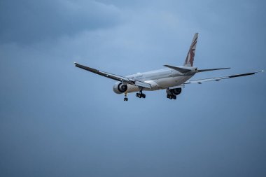 Ho chi minh, vietnam - Feb 27, 2024: Qatar airways  registration flying on cloudy day, approaching landing in Tan Son Nhat Airport in Vietnam clipart