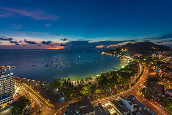 Vung Tau, VIETNAM 3 Mayıs 2024: Güzel günbatımı ve tekneleri olan üst manzara. Vung Tau 'nun yukarıdan panoramik manzarası dalgalar, sahil, sokaklar, hindistan cevizi ağaçları ve Vietnam' daki Tao Phung dağları.