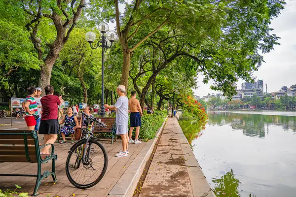 stock image Hanoi, Vietnam - 26 June 2024 : Hoan Kiem lake or Sword lake, Ho Guom in Hanoi, Vietnam with Turtle Tower, on clear day with blue sky and white clouds