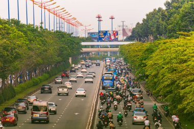 Ho Chi Minh şehri, Vietnam - 30 Aralık 2024: Trafiğin yoğun olduğu saatler ve Saigon caddelerinde trafik yoğun, kalabalık insanlar ve motosikletler