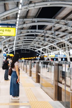 Ho Chi Minh city, Vietnam - 30 Dec 2024: People wait at Thao Dien metro station, line 1 is expected to be operational by the end of 2024 in Ho Chi Minh City. clipart