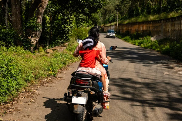 A split-second decision unfolds as a mother instinctively protects her daughter on a scooter