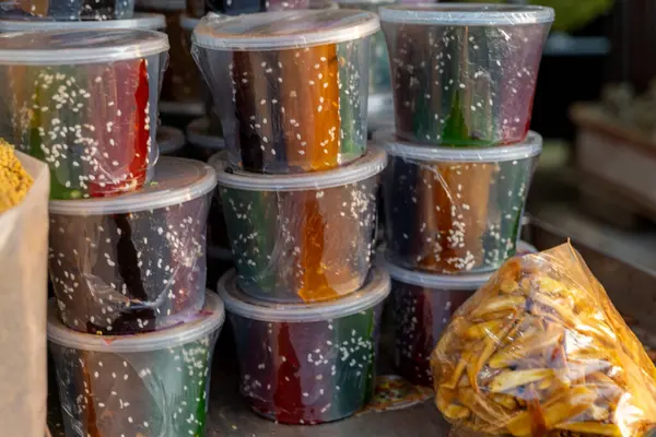 Yerel bir markette satılığa çıkarılmış şeffaf kaplarda düzgünce paketlenmiş geleneksel bir halwa dizisi..