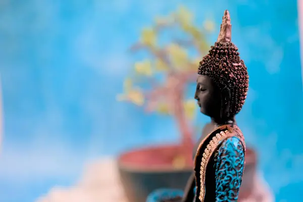 Stock image A peaceful image featuring a Buddha statue bathed in soft blue light. Perfect for meditation backgrounds