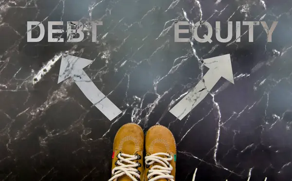 stock image Image showing the decision between debt and equity, with arrows pointing in opposite directions. Financial choice concept.