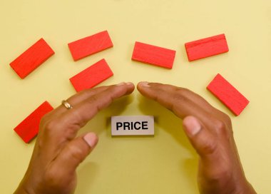 Eller, kırmızı bloklarla çevrili hassas bir 