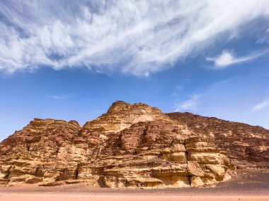 Magical desert landscape showing the vast rock formations under the cloudy blue sky